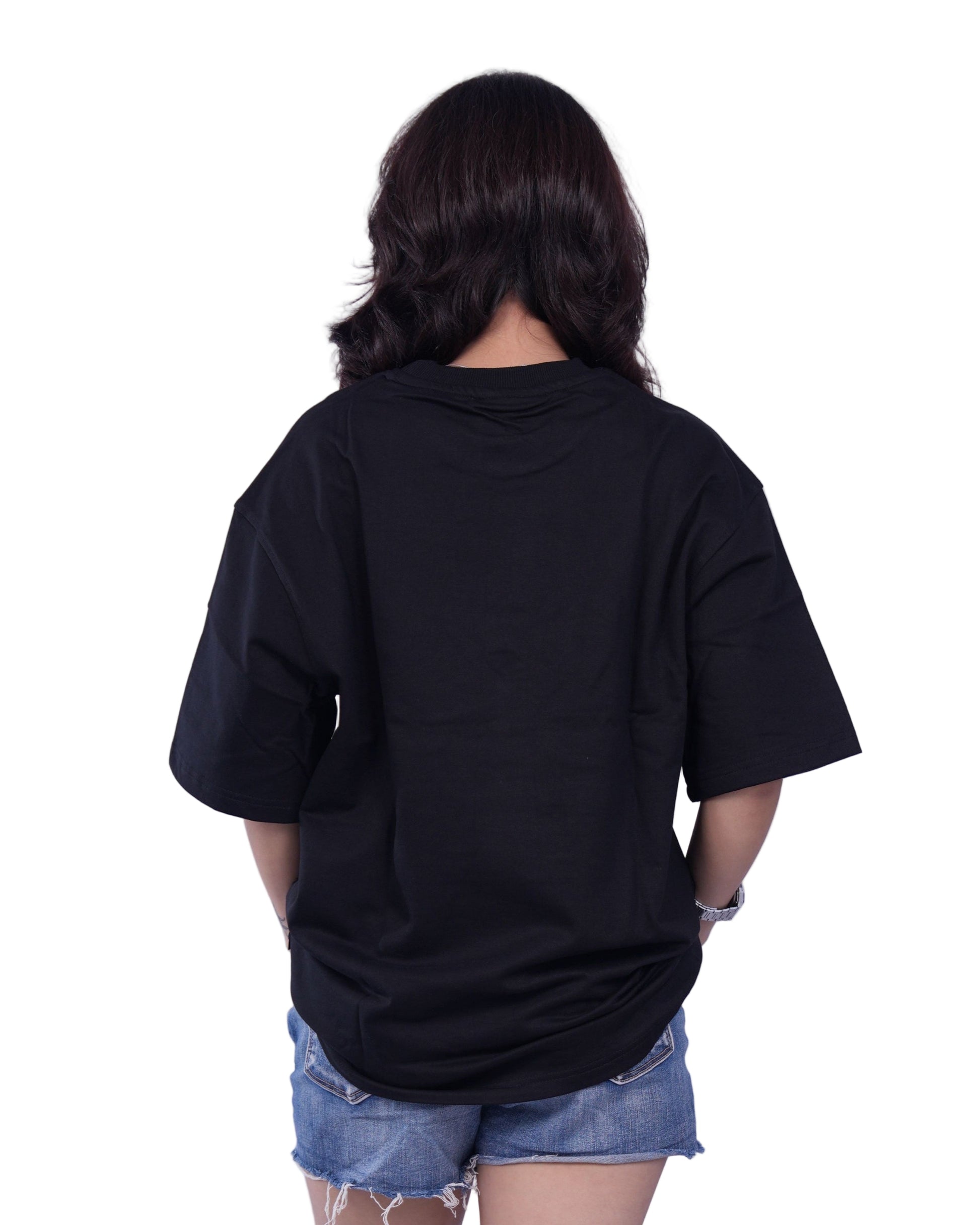 Person wearing a black oversize t-shirt
