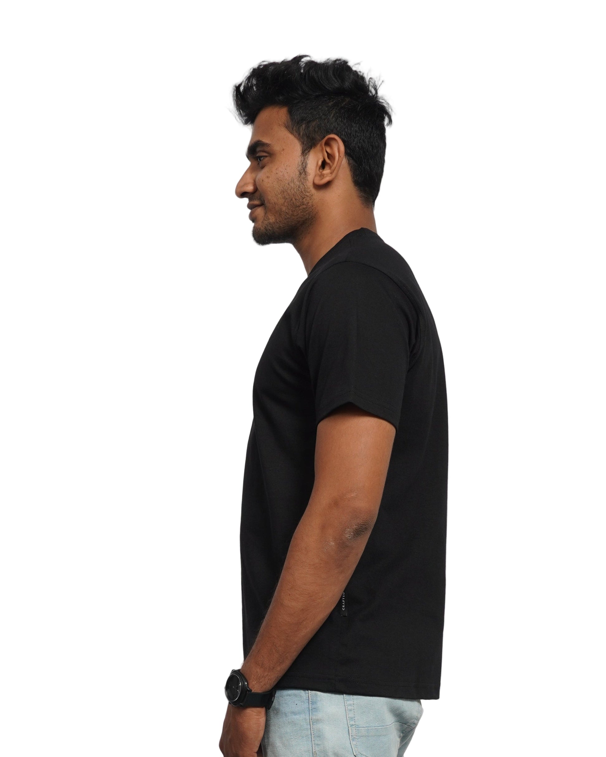 Person wearing a black shirt and jeans on a background