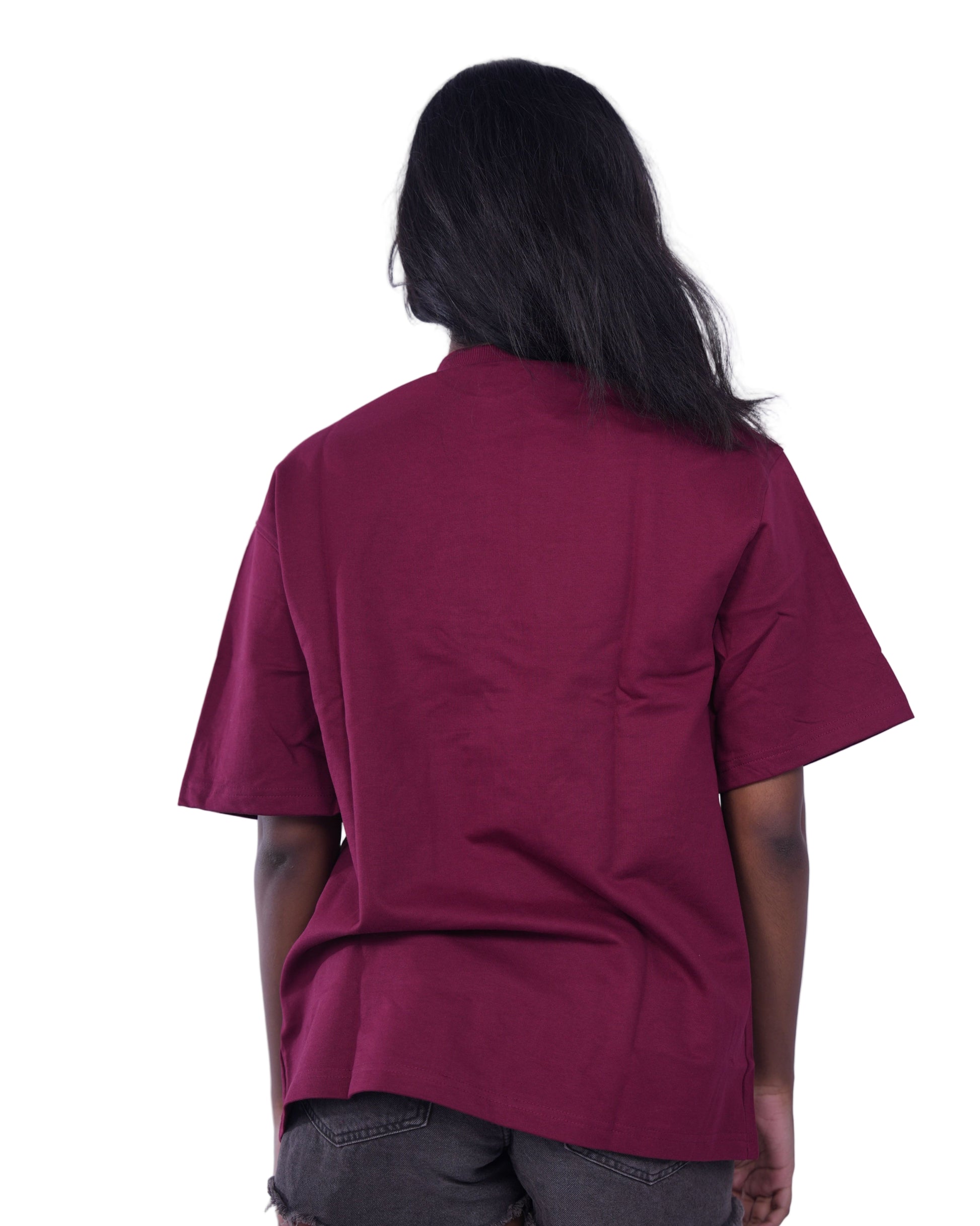 Person wearing a Maroon oversize t-shirt 