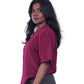 Person wearing a Maroon oversize T-shirt