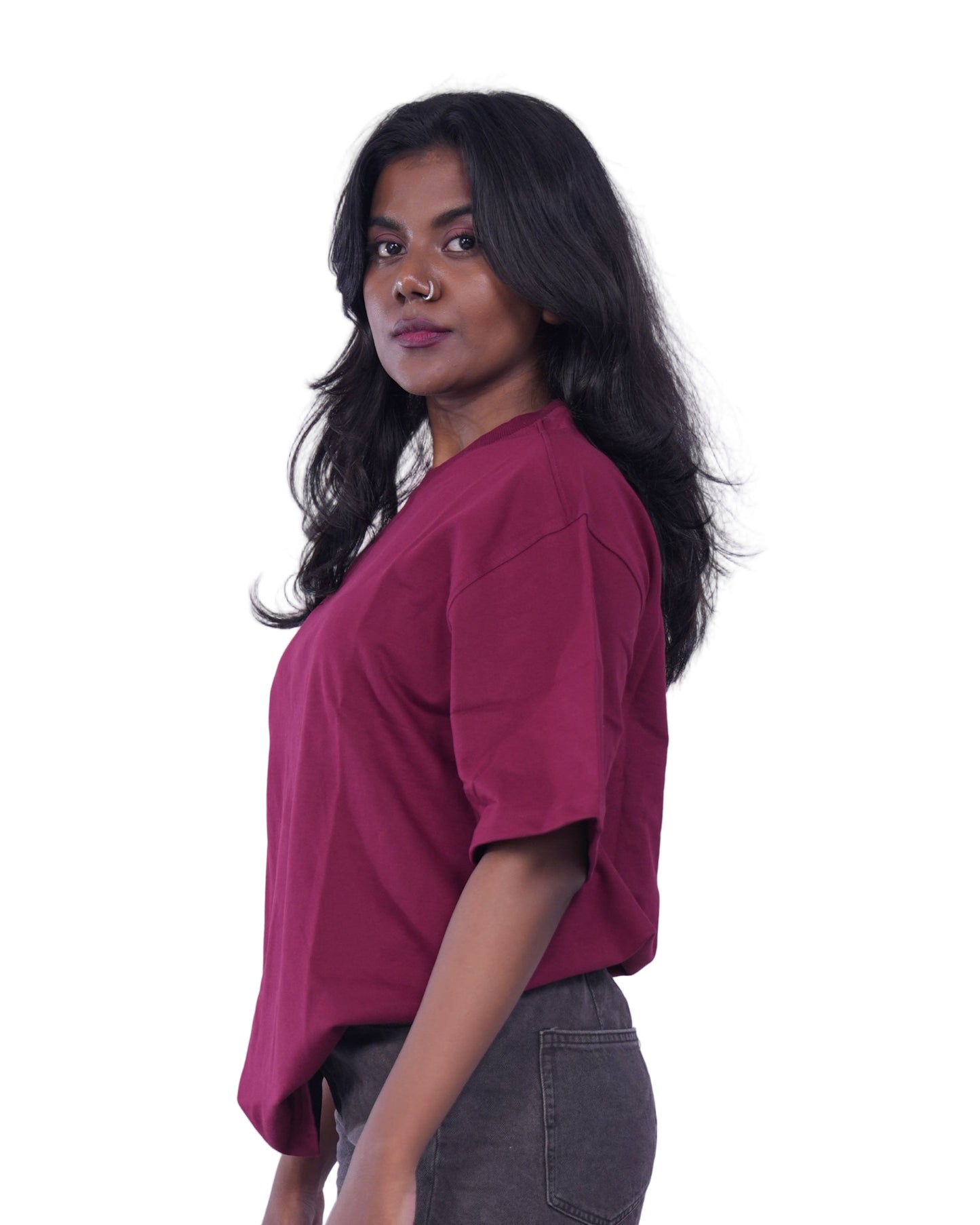 Person wearing a Maroon oversize T-shirt