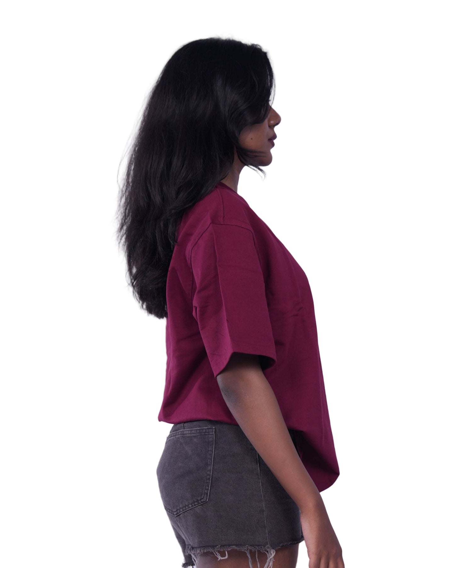 Person wearing a Maroon oversize t-shirt 