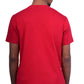 Person wearing a red shirt and black shorts on a white background
