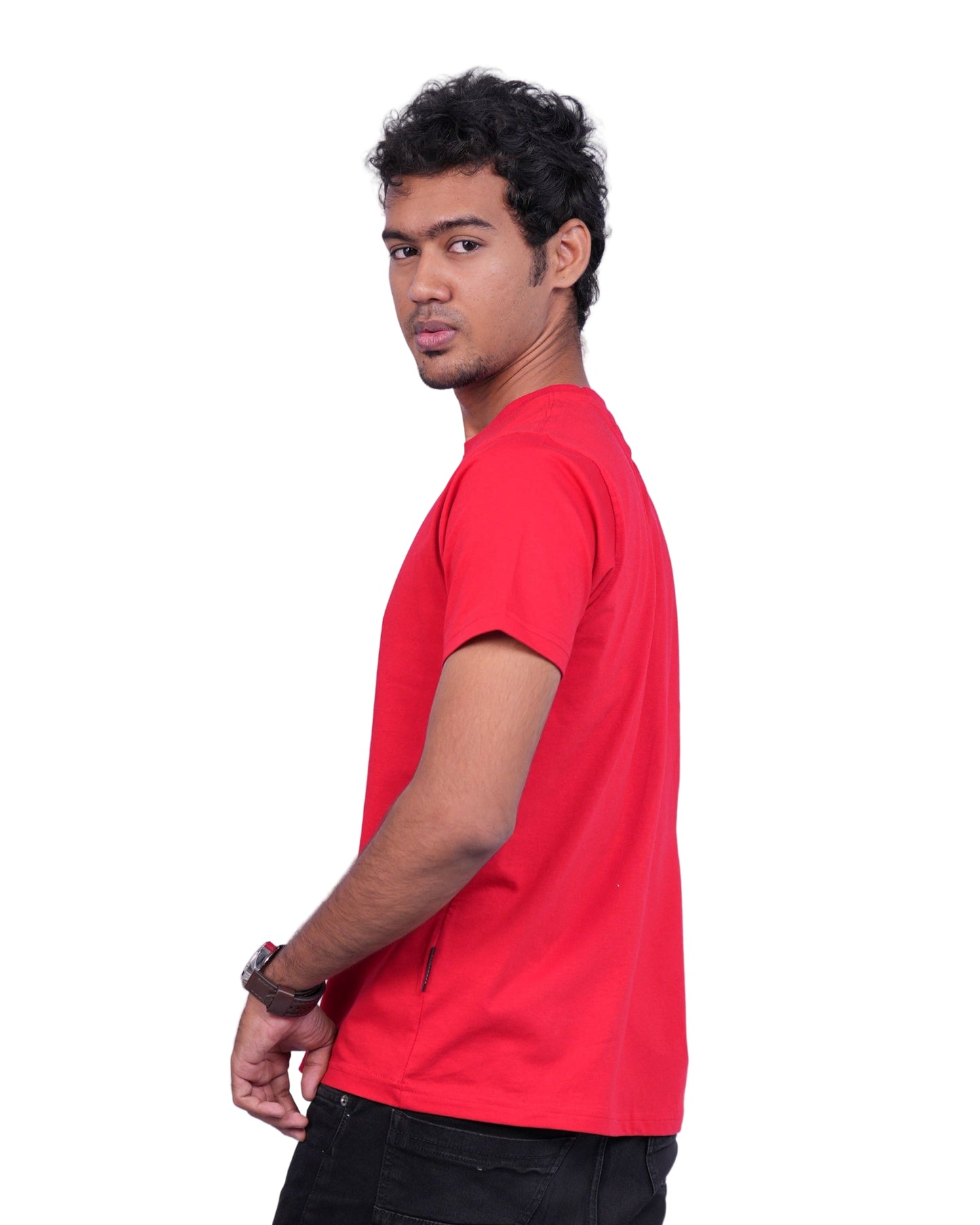 Person wearing a red shirt and black pants on a white background