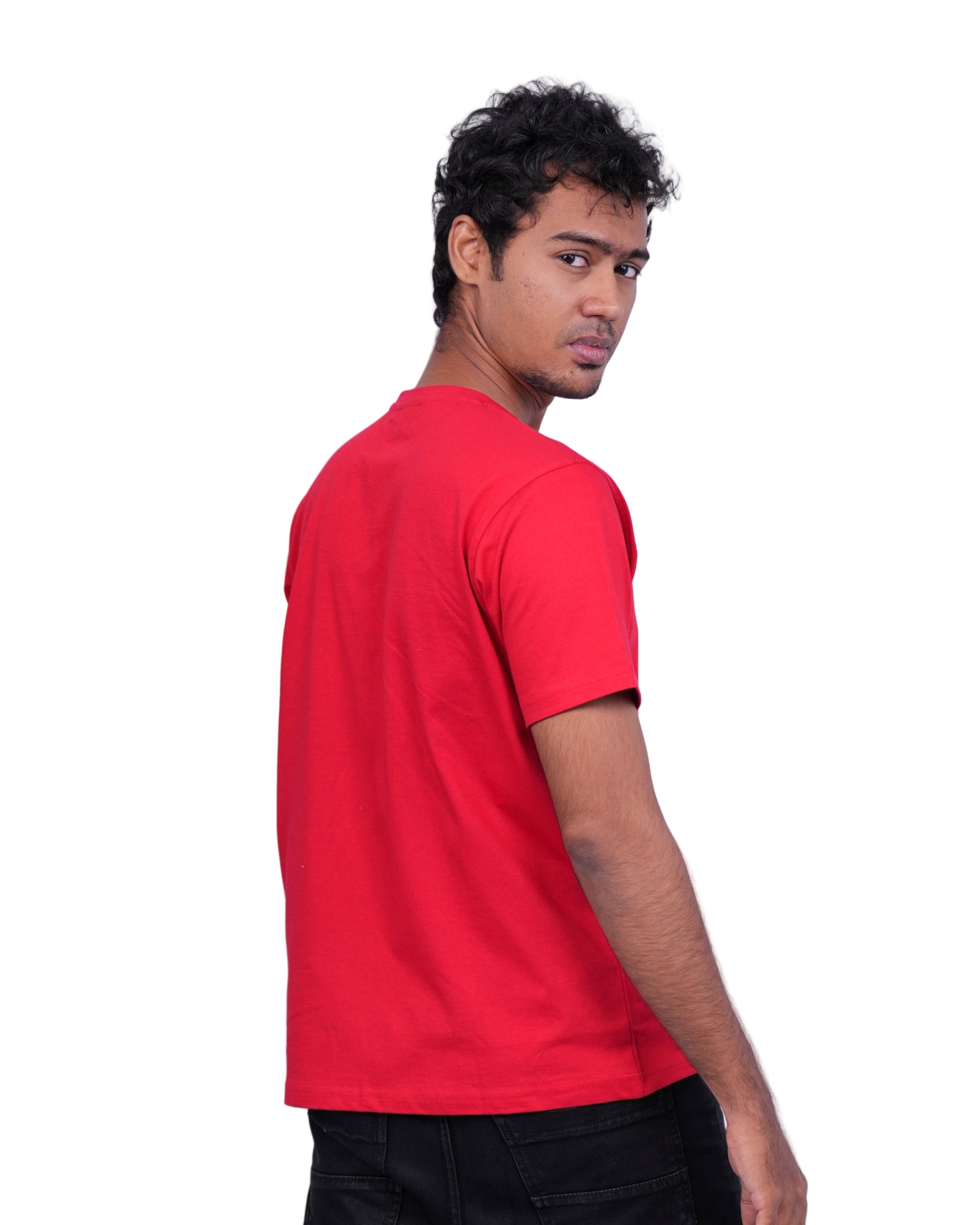 Person wearing a red shirt and black pants on a white background