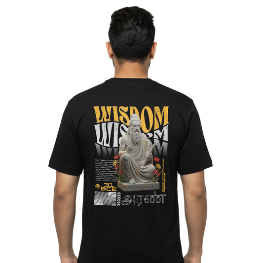 Back view of black “Thiruvalluvar the Wisdom” T-shirt with large Thiruvalluvar statue and Wisdom typography graphic on male model, regular unisex fit by Crafted Community