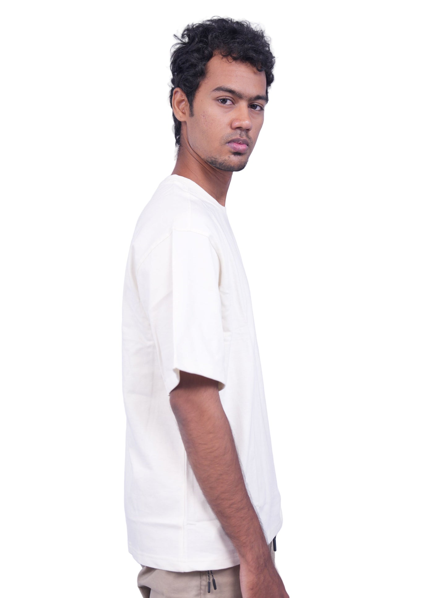 Person wearing a cream oversize t-shirt 