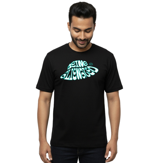 Front view of “Being Aligned – defining My Space Typography Tee” on male model, featuring teal wavy typography graphic on chest, regular fit T-shirt by Crafted Community black 