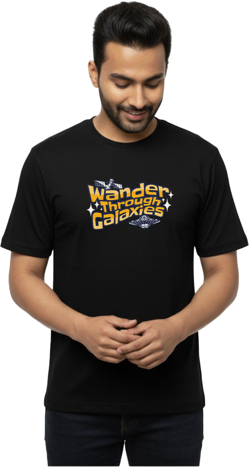Front view of man in black “Wander Through Galaxies – Space Wanderer” graphic T-shirt with sci-fi lettering and small spaceship motif
